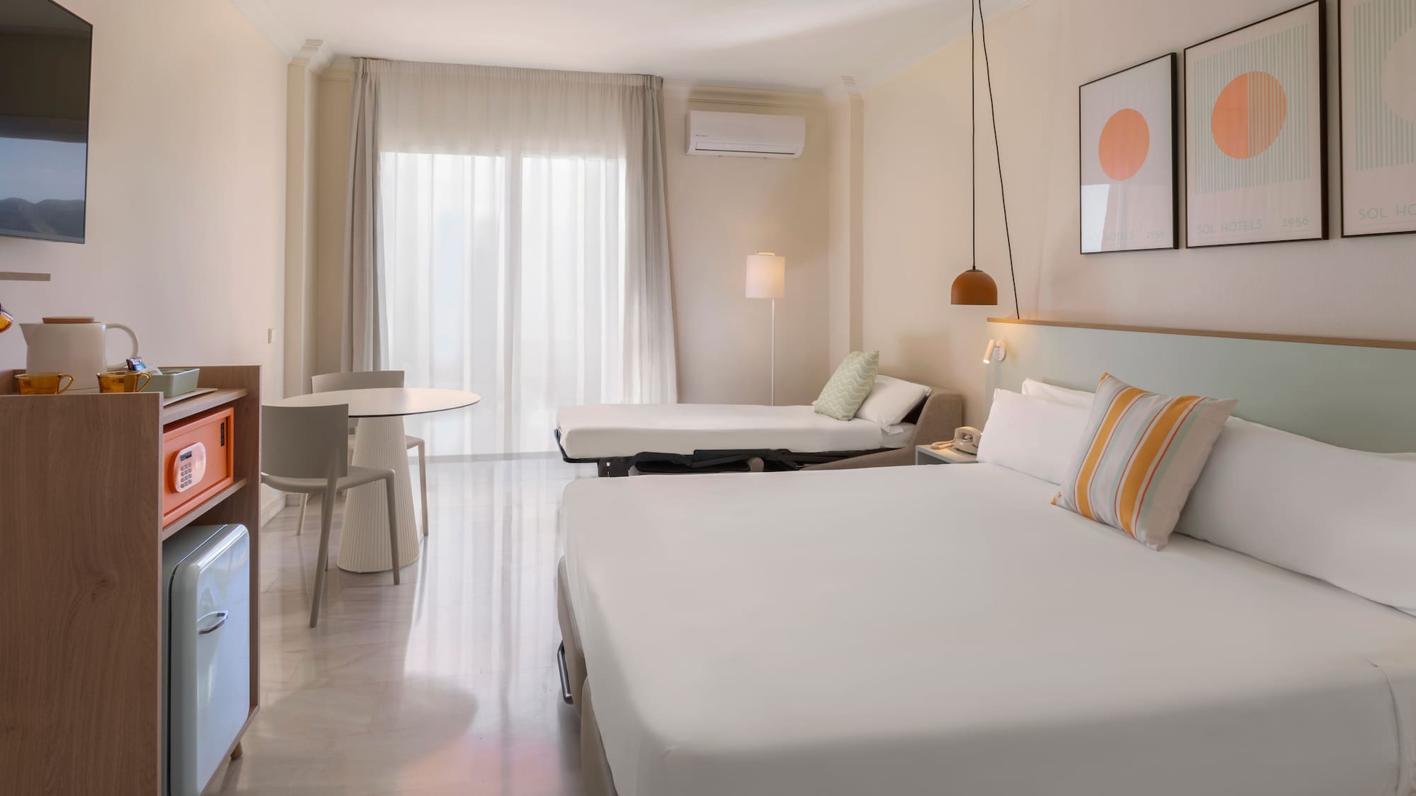 a room with a bed and a television