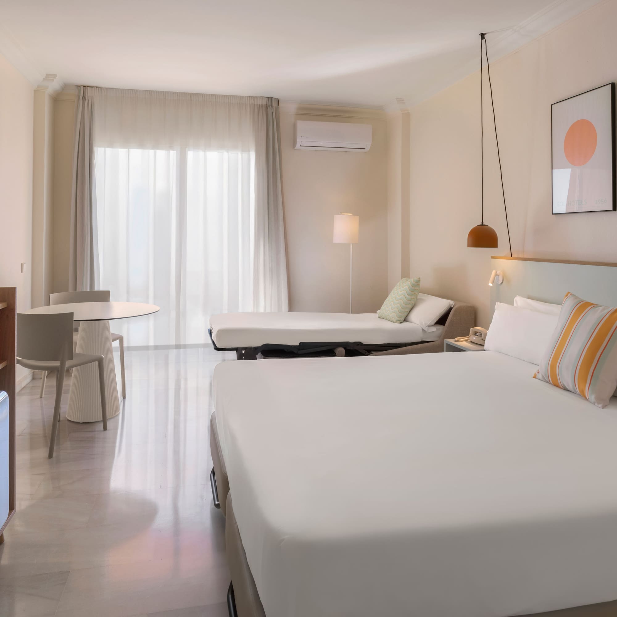 a room with a bed and a television