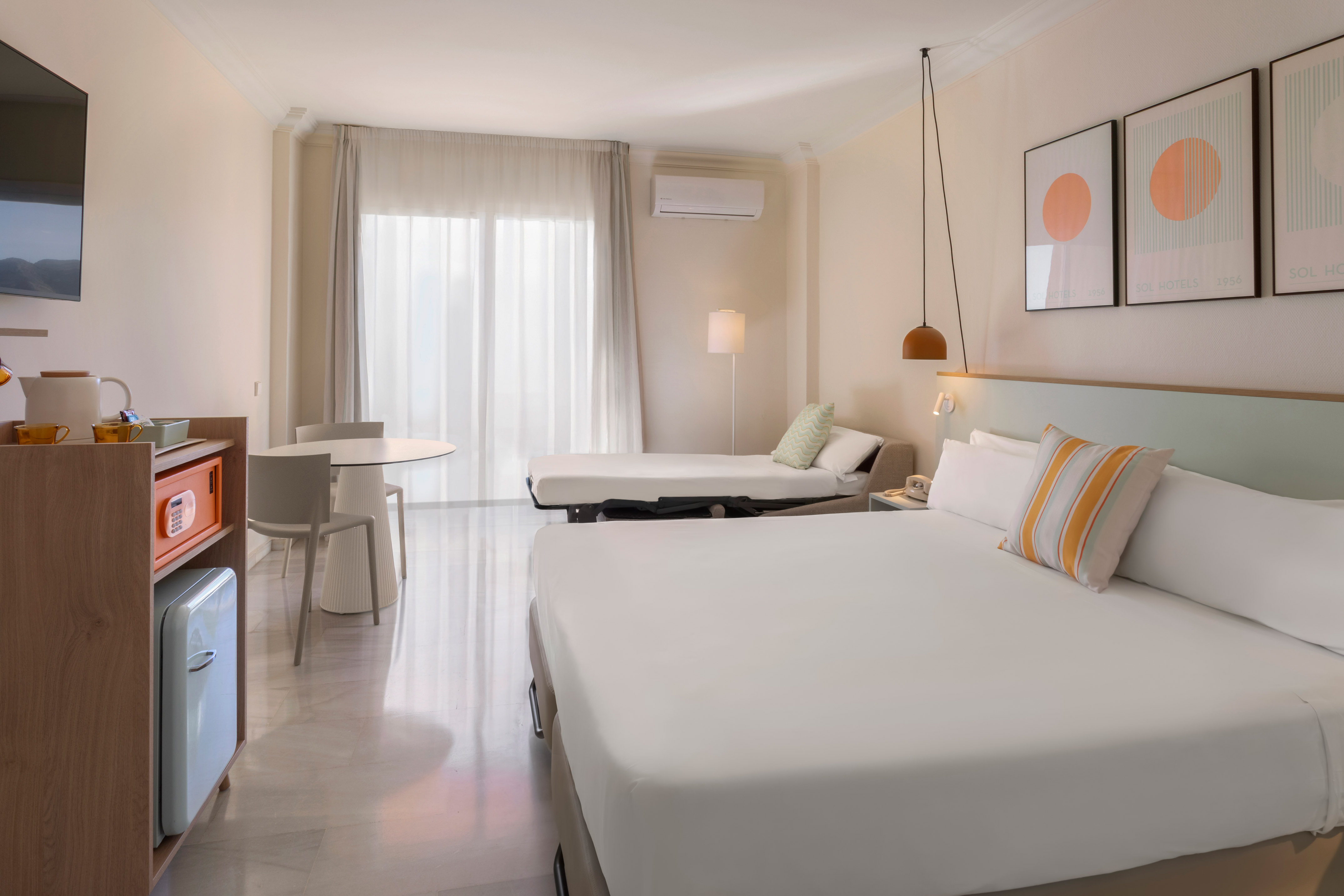 a room with a bed and a television