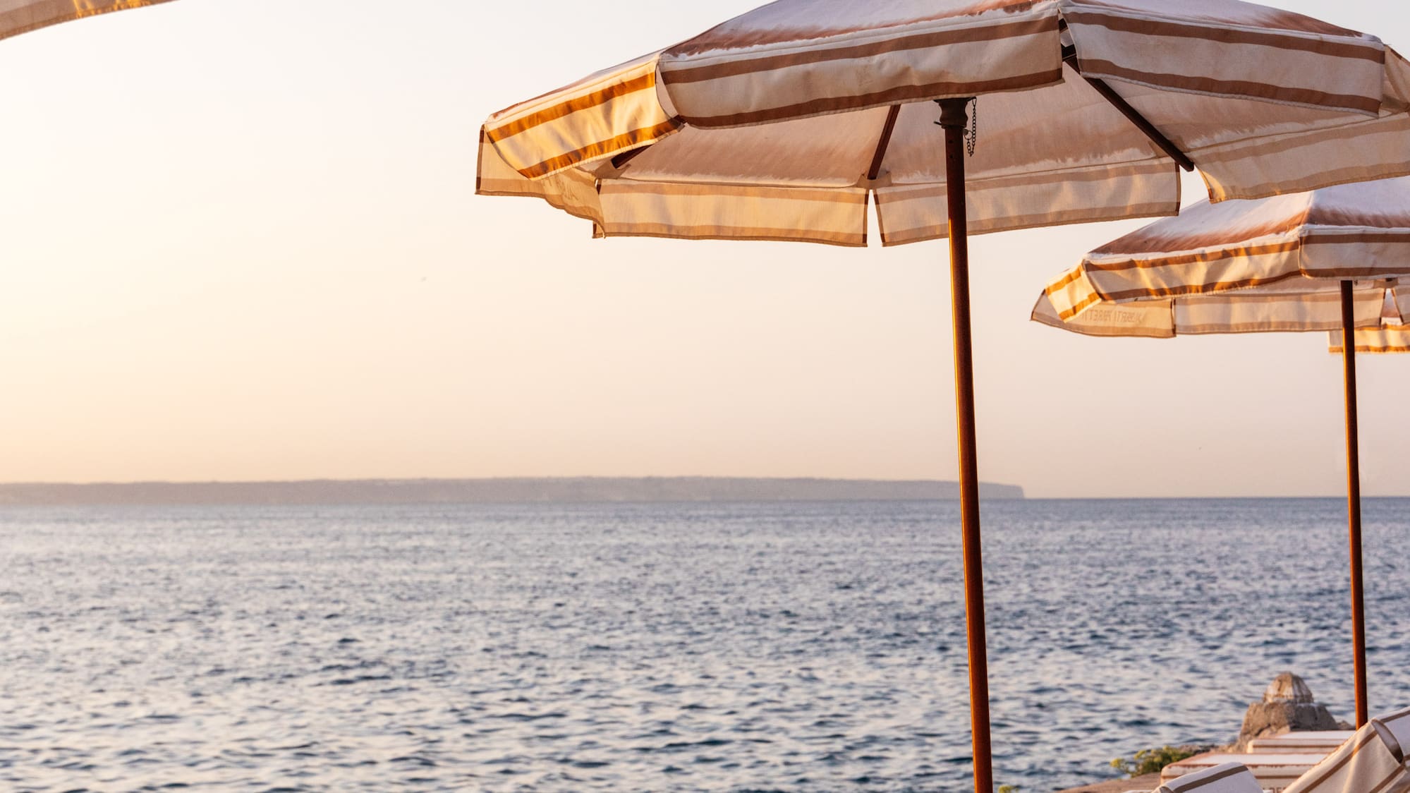 a group of chairs and umbrellas on a beach