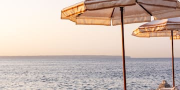 a group of chairs and umbrellas on a beach