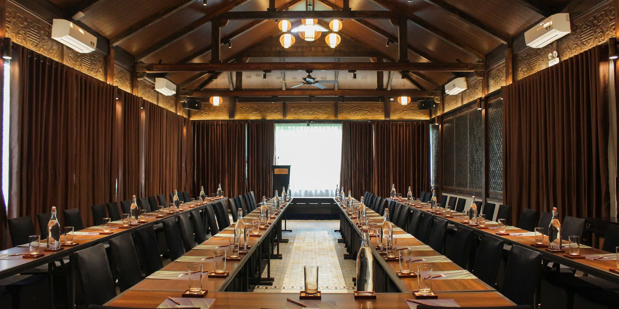 a room with long tables and chairs