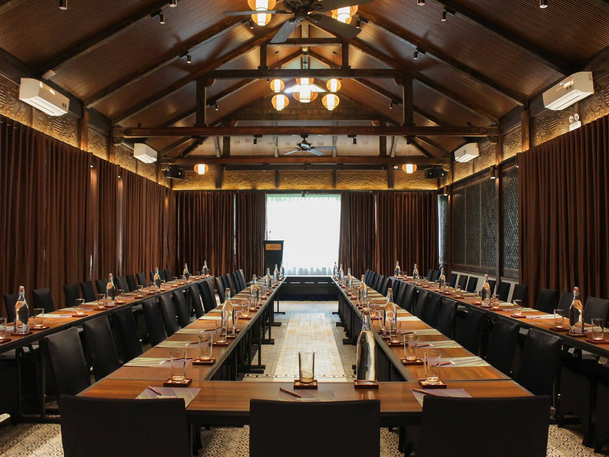 a room with long tables and chairs