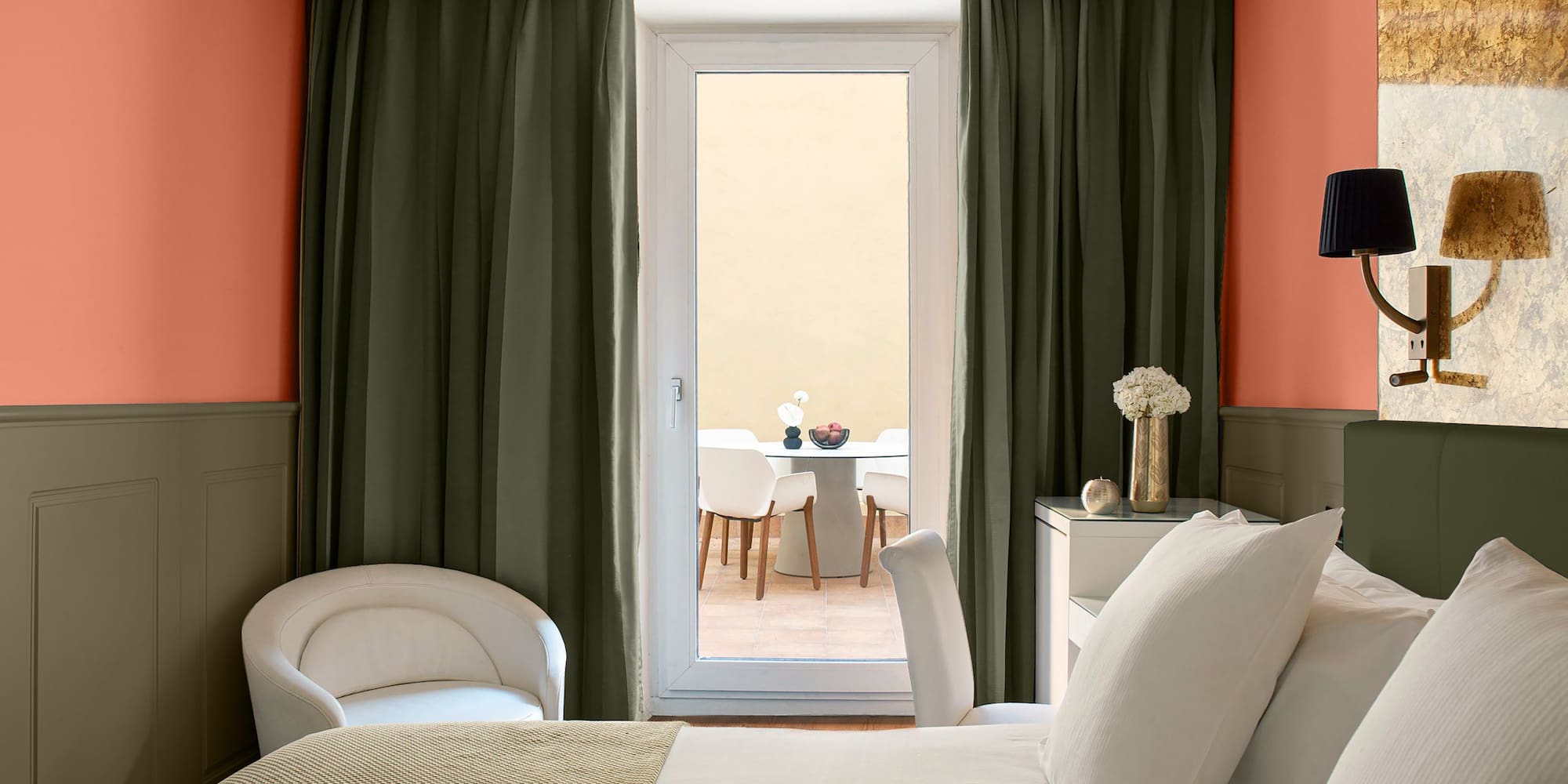 a room with a bed and chairs