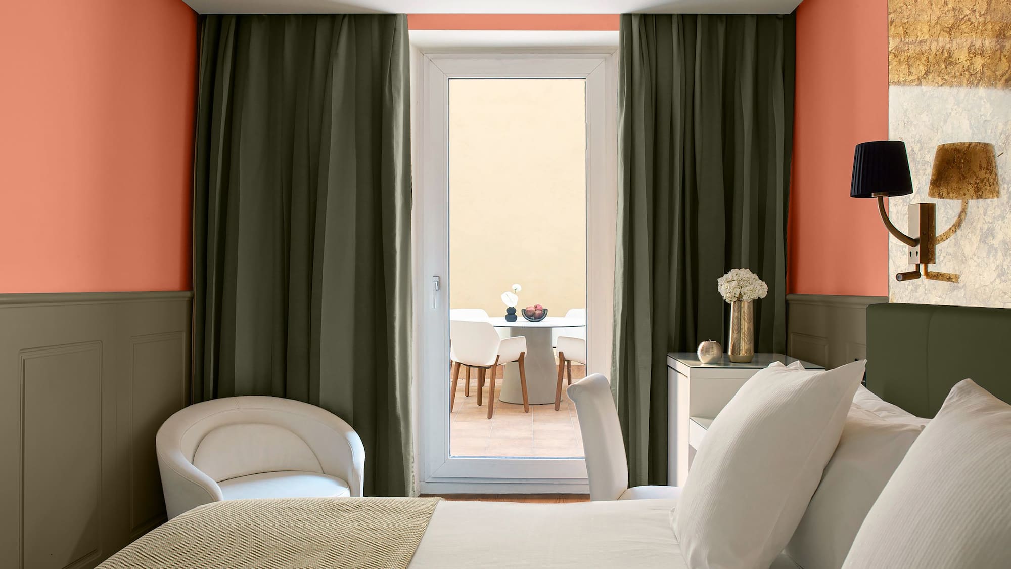 a room with a bed and chairs