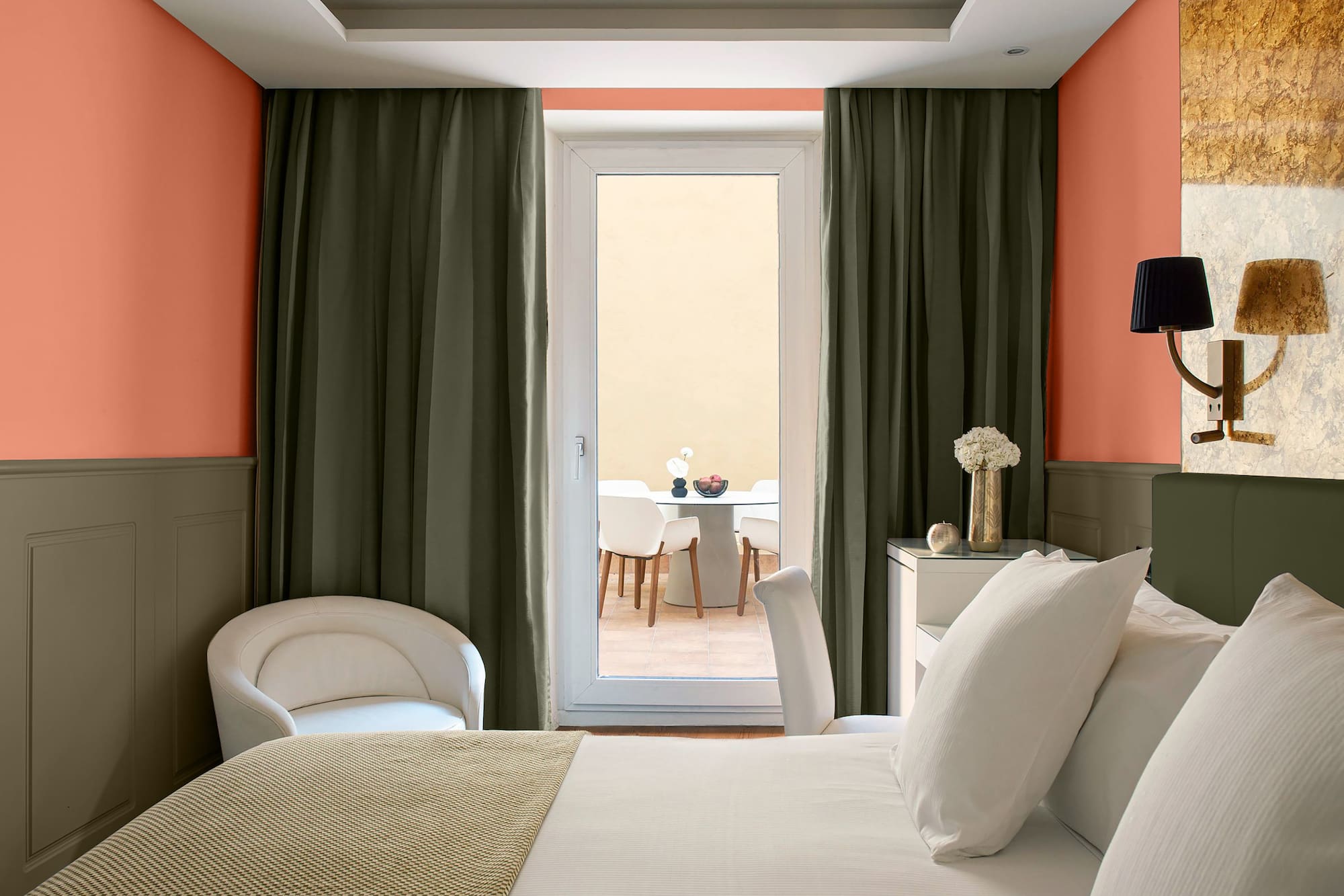 a room with a bed and chairs