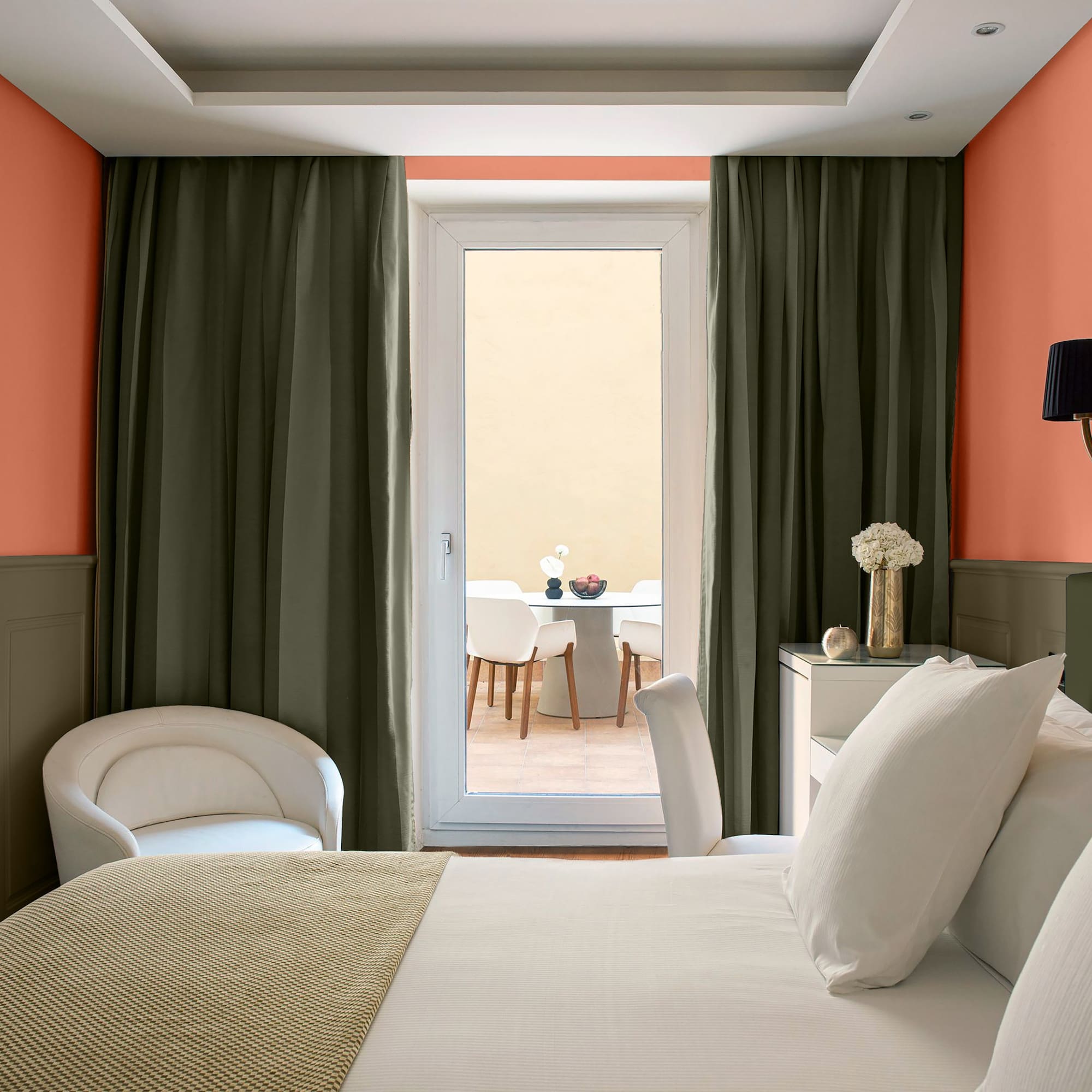 a room with a bed and chairs