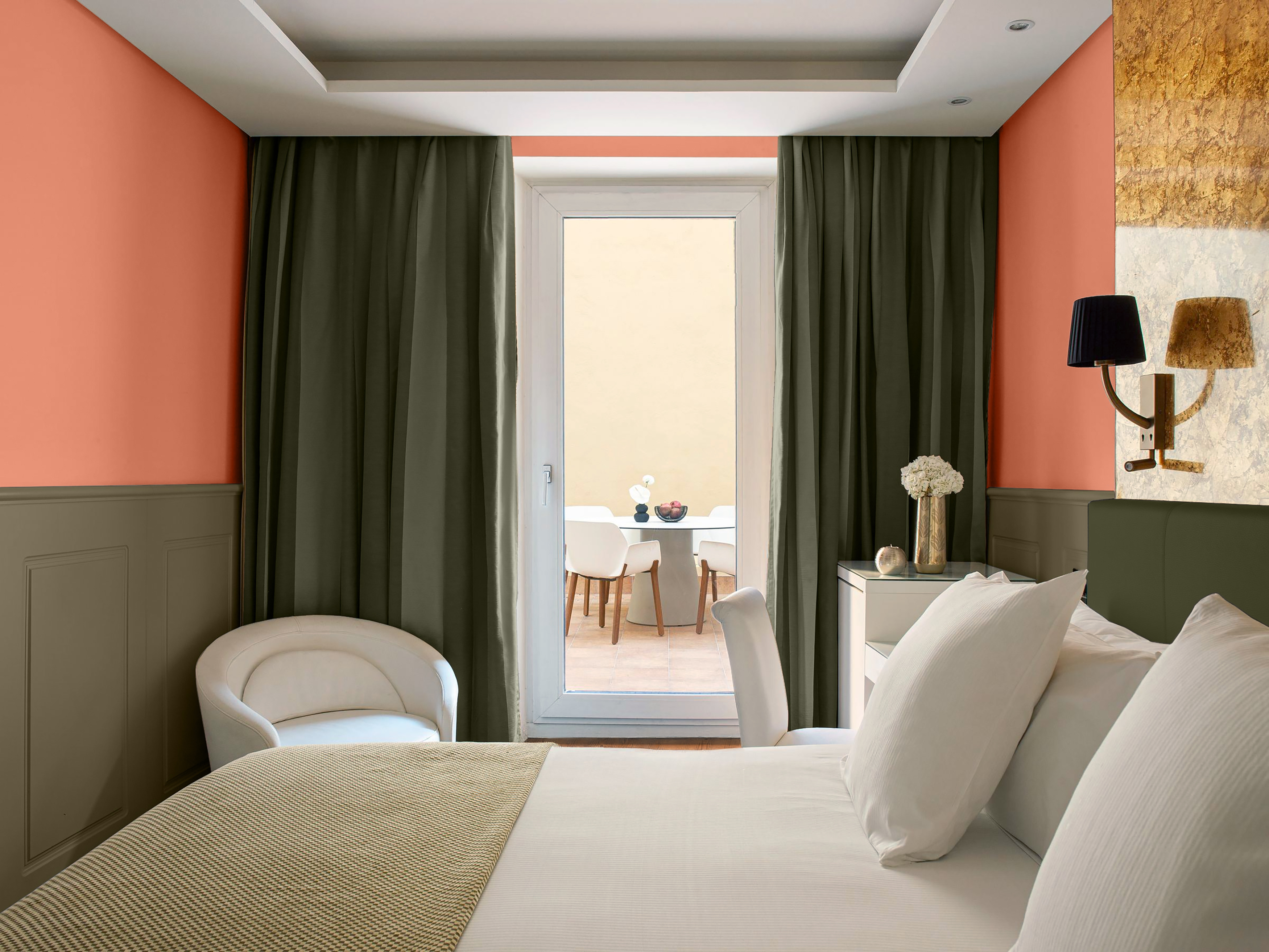 a room with a bed and chairs