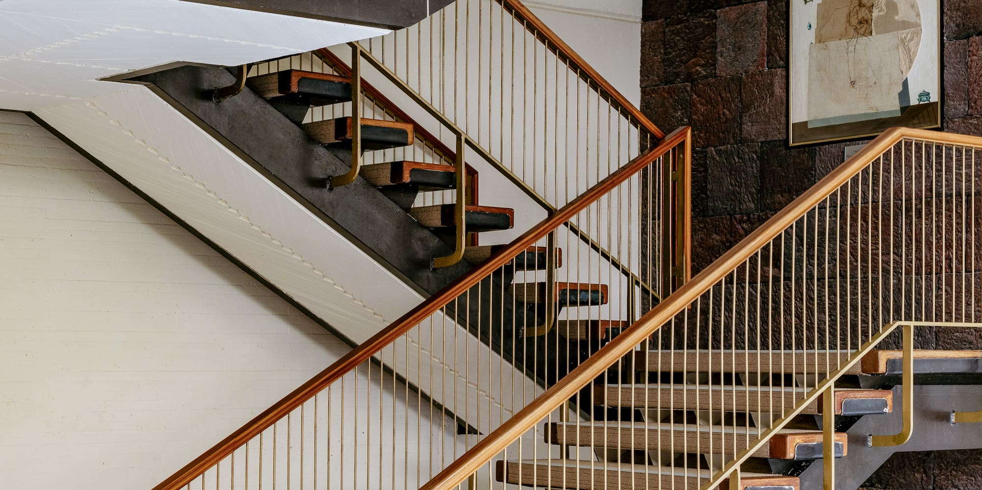 a staircase with gold railings
