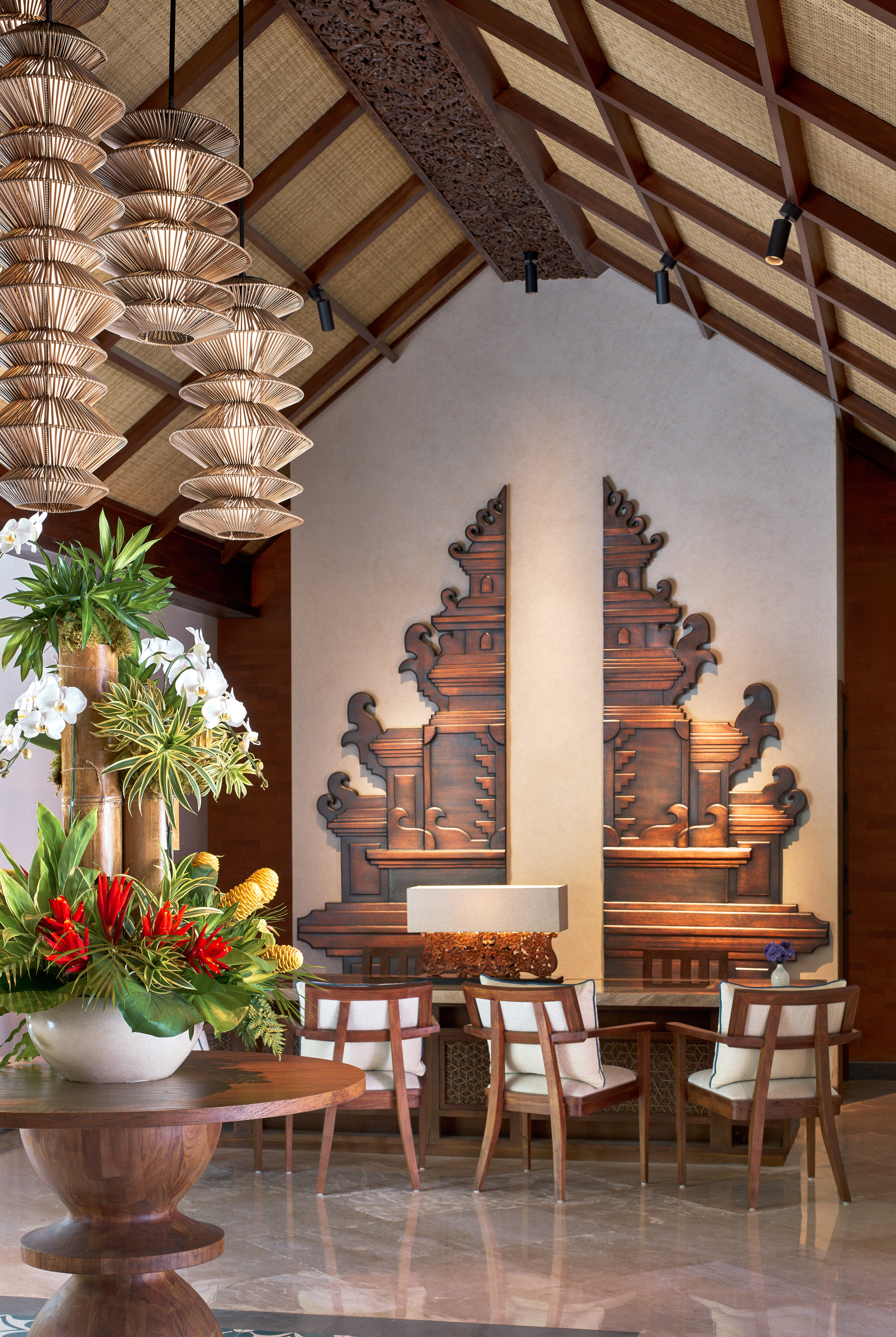 a room with a table and chairs and a vase of flowers