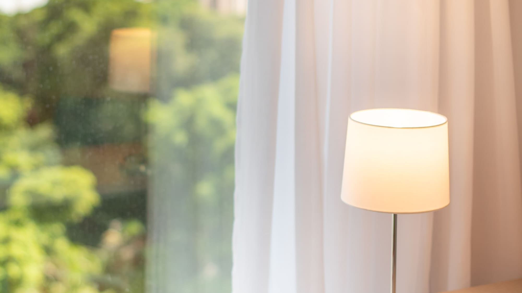 a book on a table next to a lamp