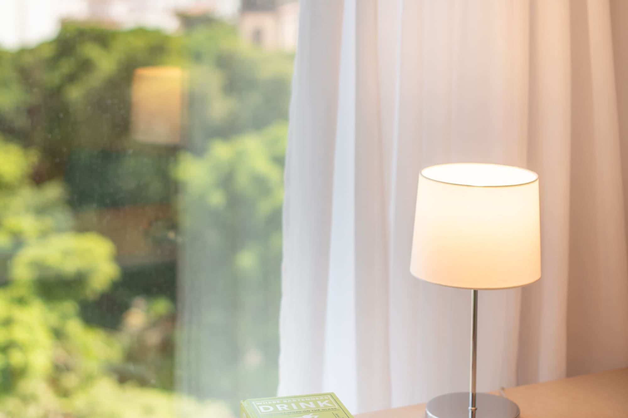 a book on a table next to a lamp