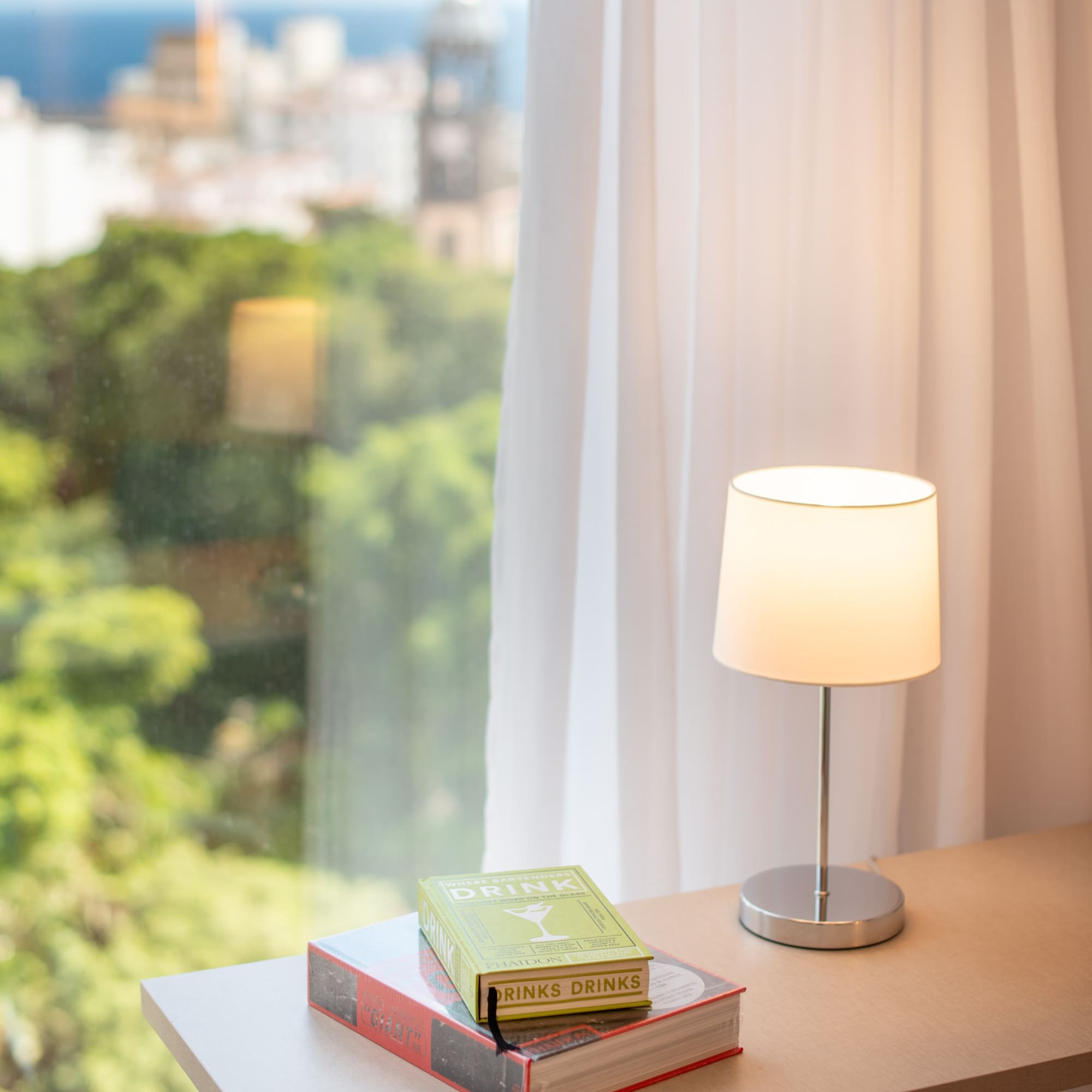 a book on a table next to a lamp