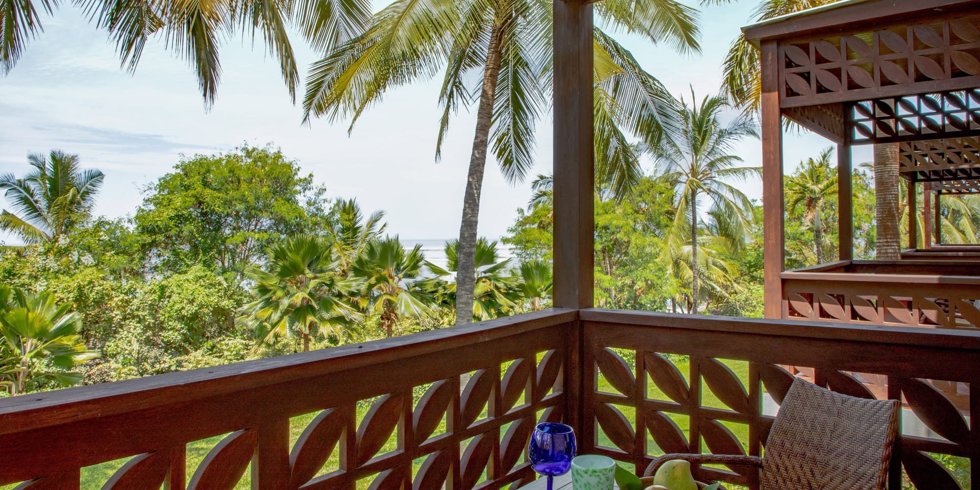 a wooden table with fruit on it and a blue glass on it