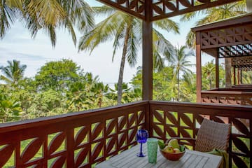 a wooden table with fruit on it and a blue glass on it