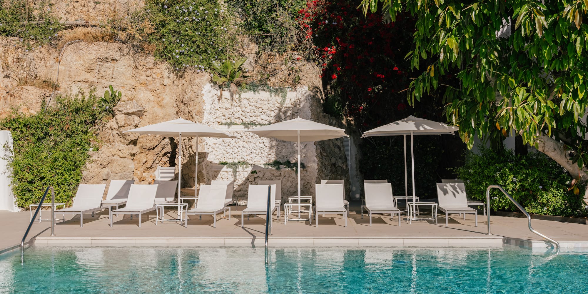 a pool with chairs and umbrellas