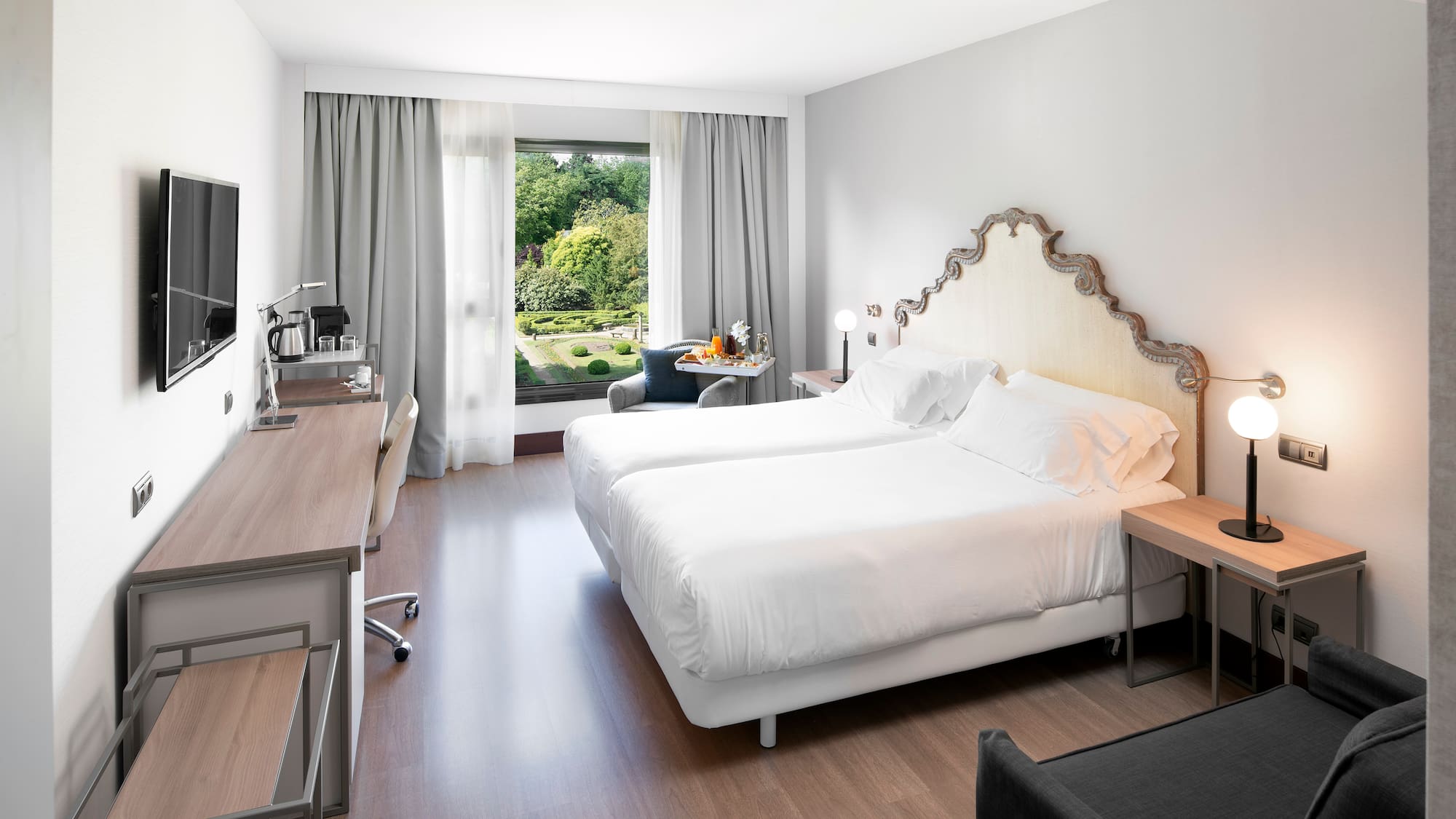 a room with two beds and a desk and a chair