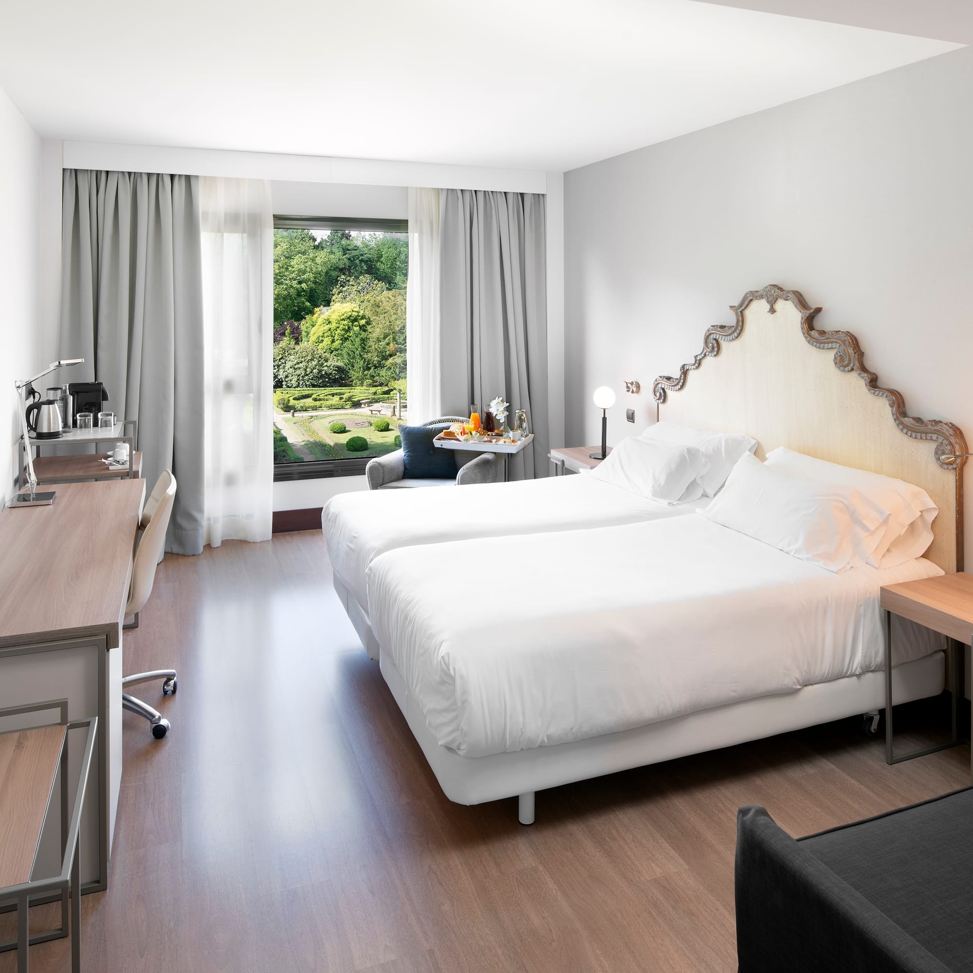 a room with two beds and a desk and a chair