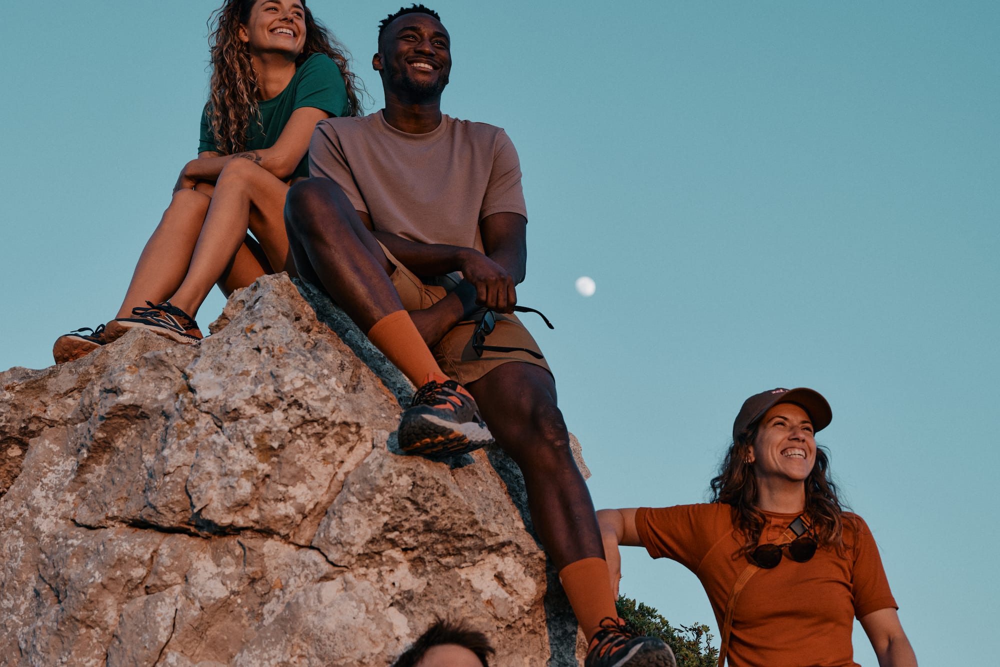 a group of people sitting on a rock