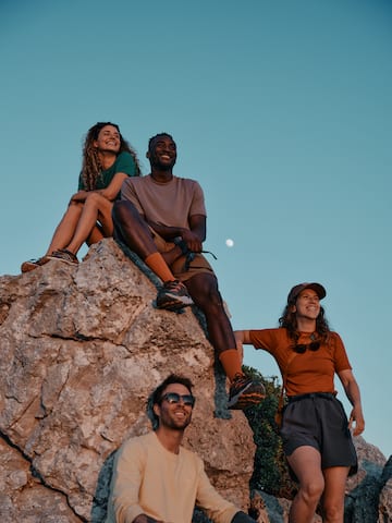 a group of people sitting on a rock