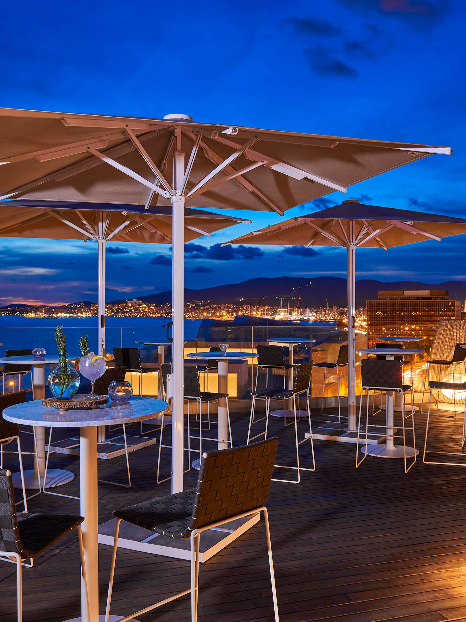 a patio with umbrellas and tables and chairs