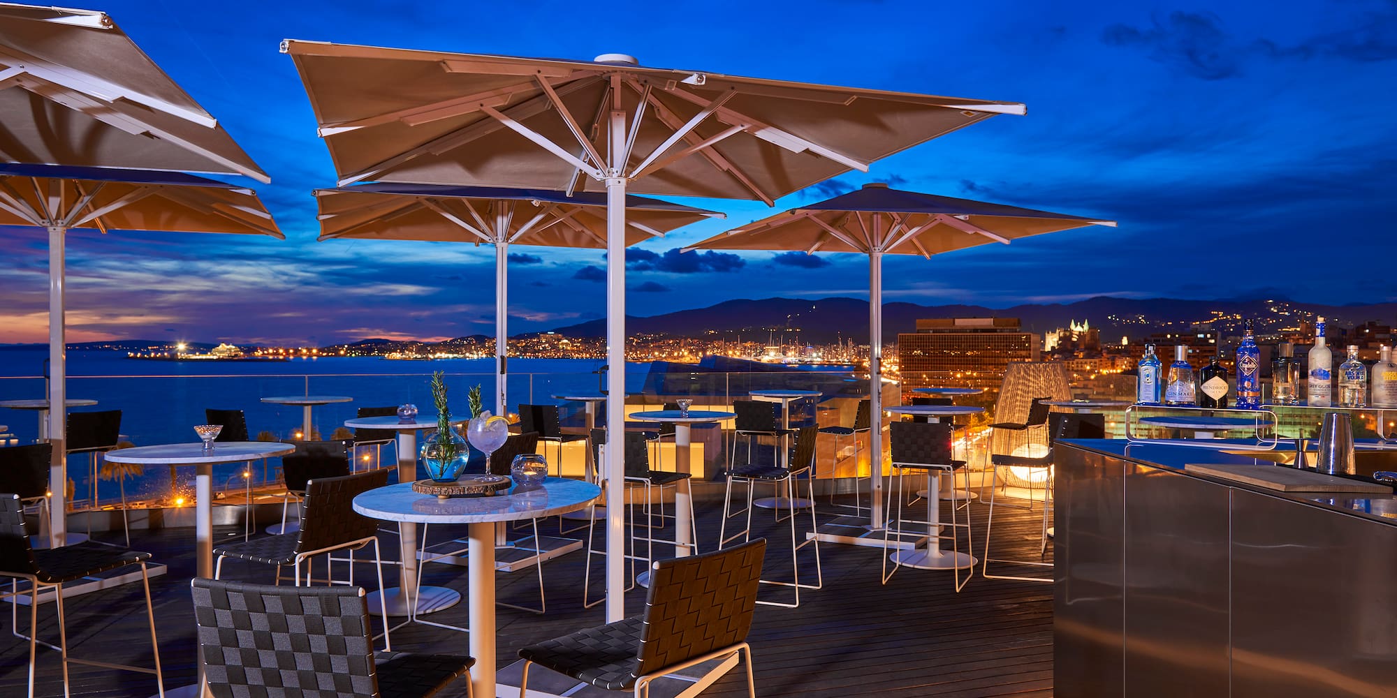 a patio with umbrellas and tables and chairs