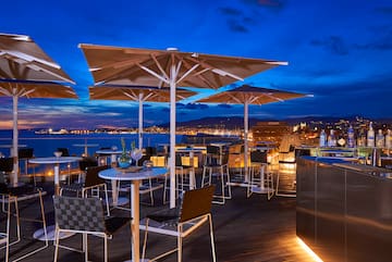 a patio with umbrellas and tables and chairs