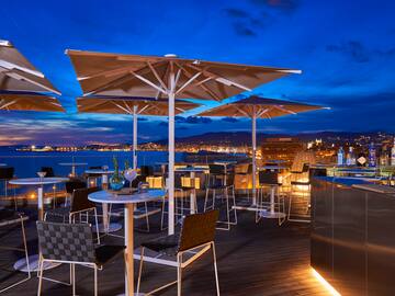 a patio with umbrellas and tables and chairs
