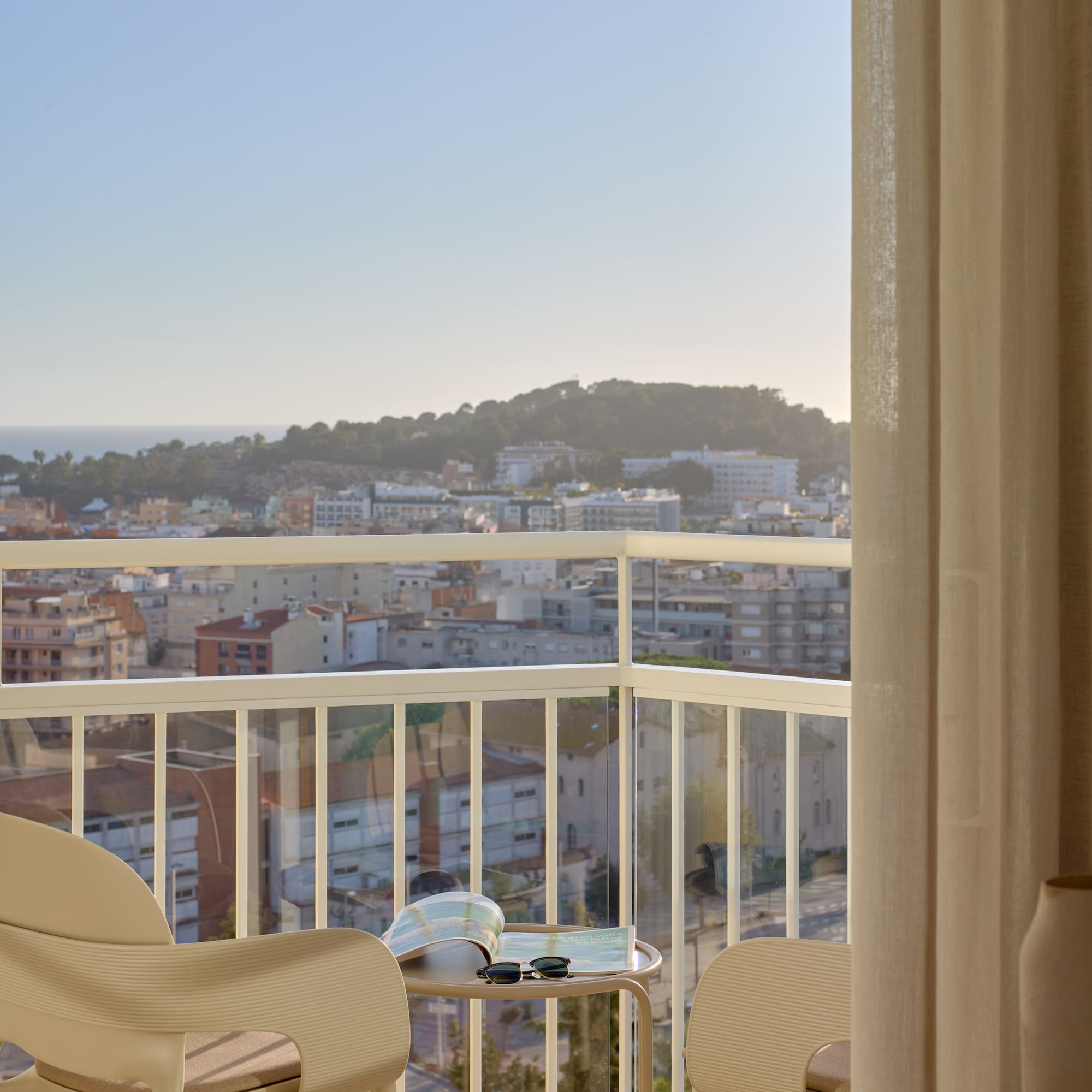 a balcony with a view of a city and a beach