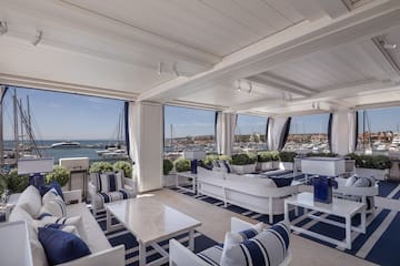 a room with a view of boats and water