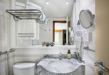 a bathroom with a sink toilet and a mirror