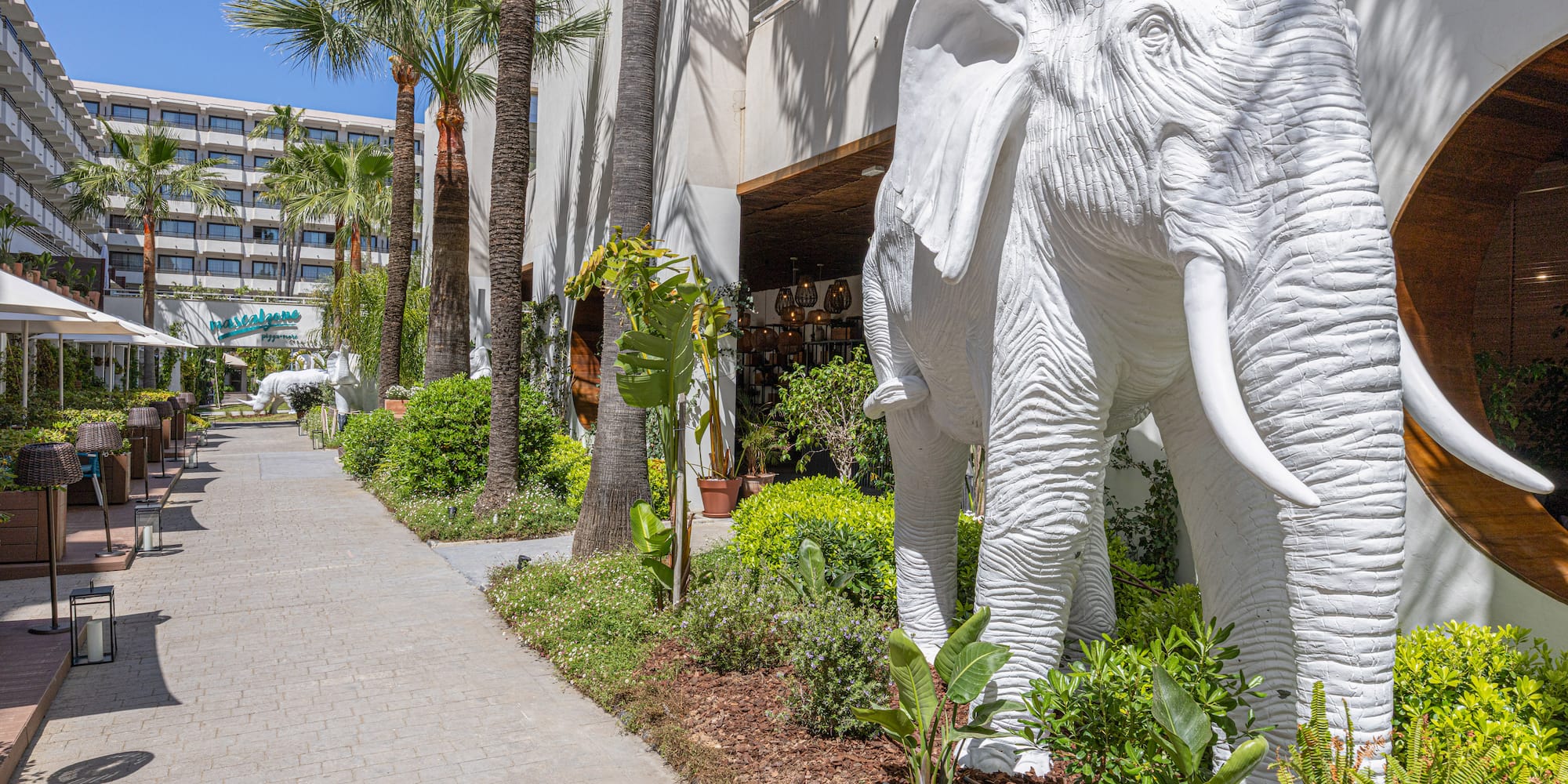 a white elephant statue next to a building