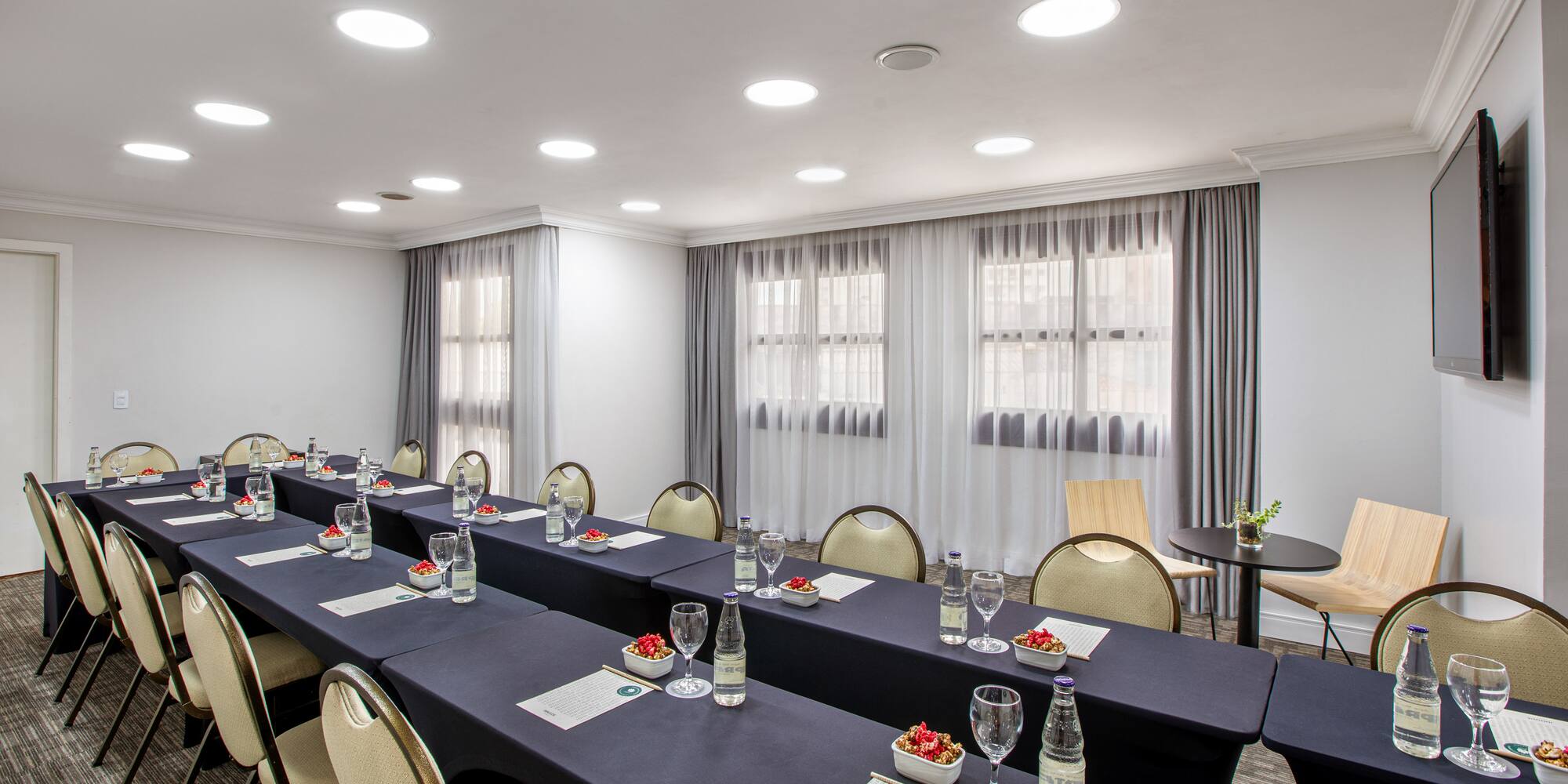 a room with long tables and chairs