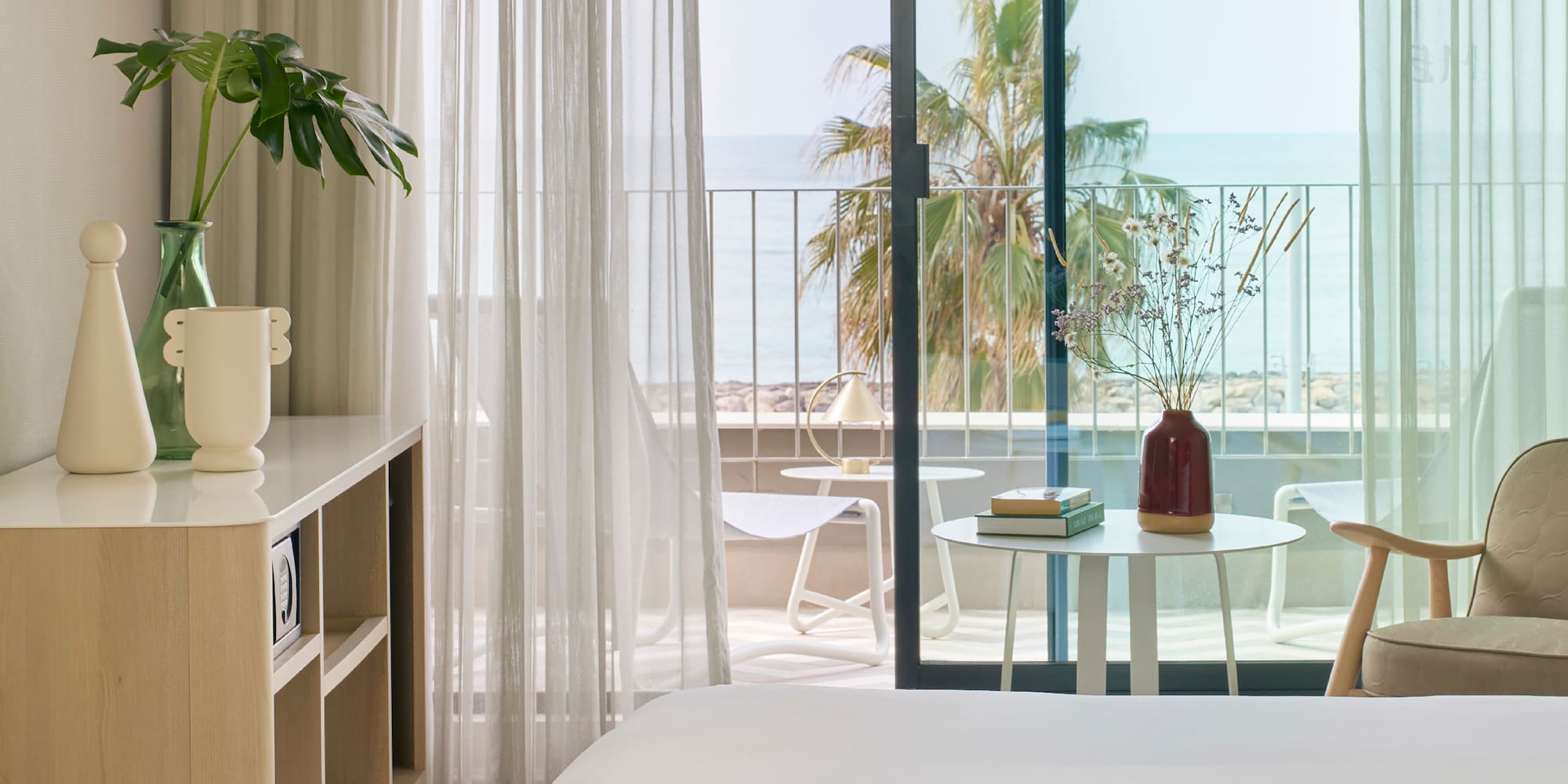 a room with a bed and a table and chairs