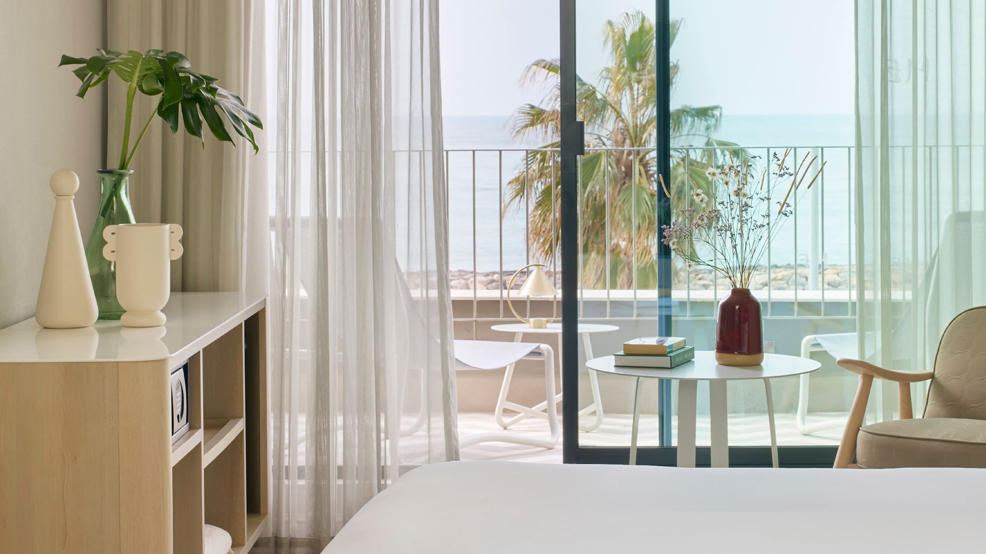 a room with a bed and a table and chairs