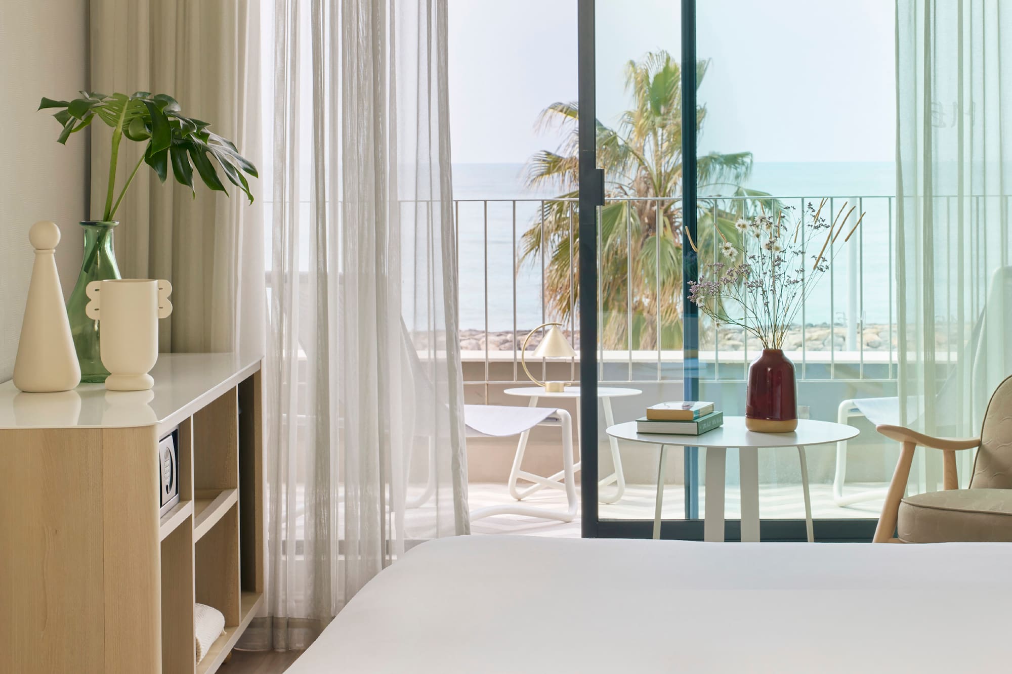 a room with a bed and a table and chairs