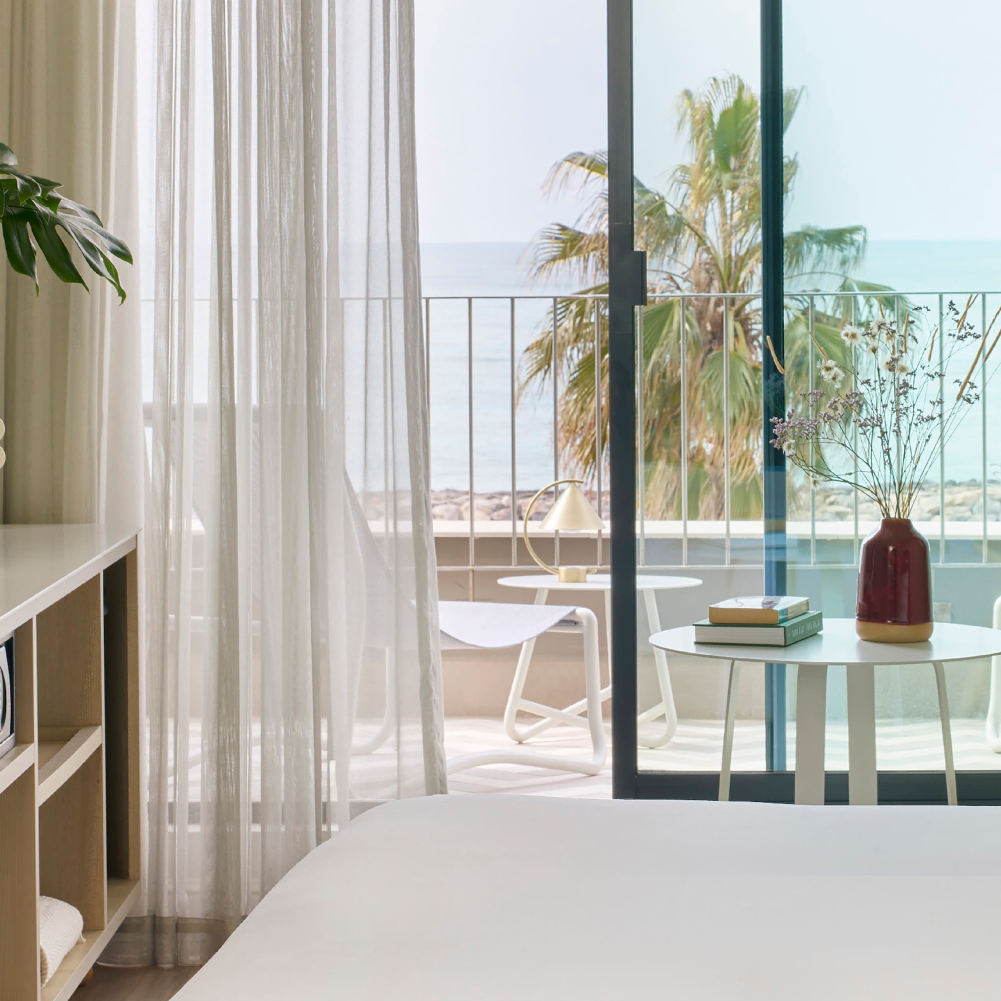 a room with a bed and a table and chairs