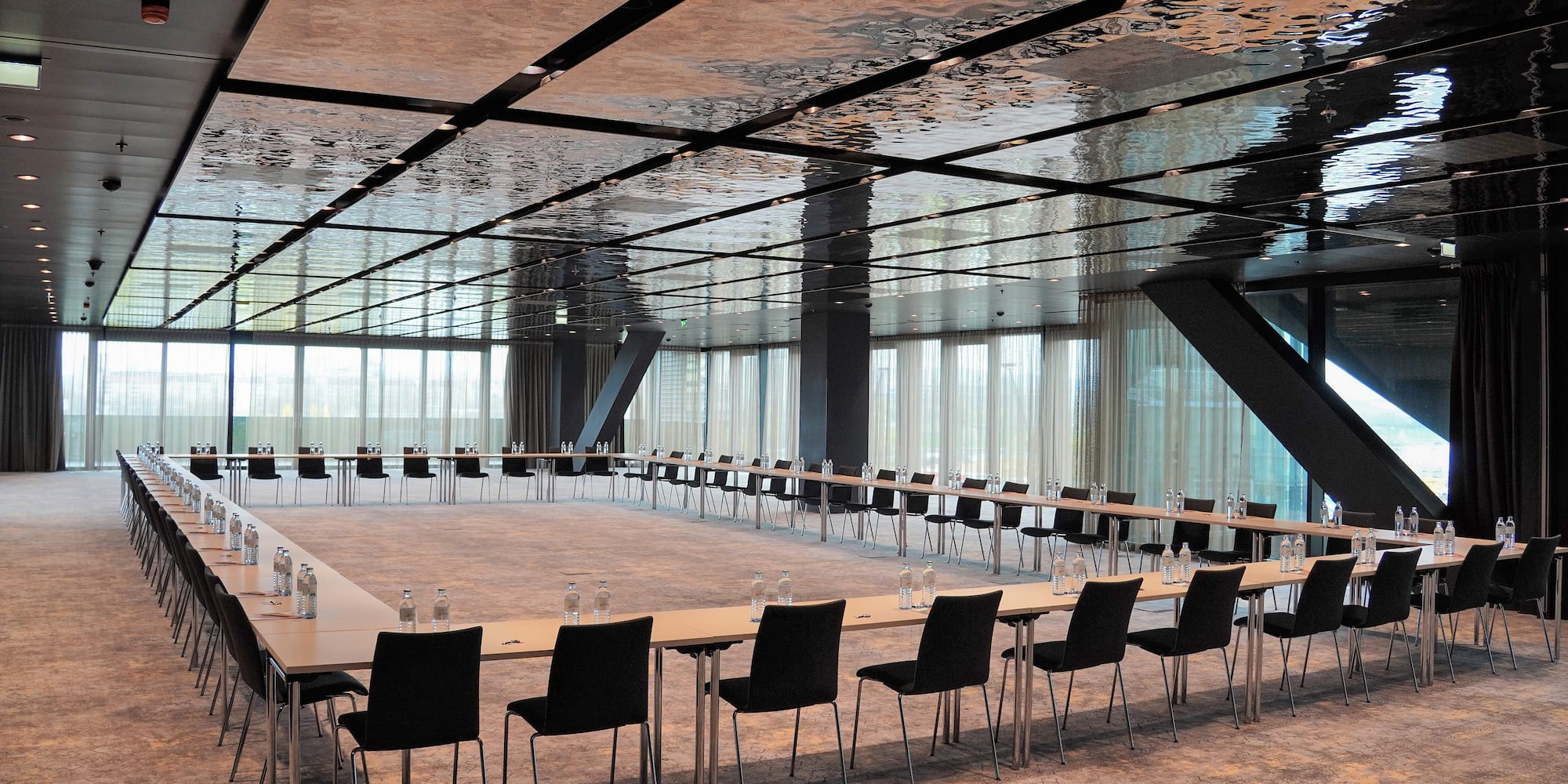 a large conference room with a long table and chairs
