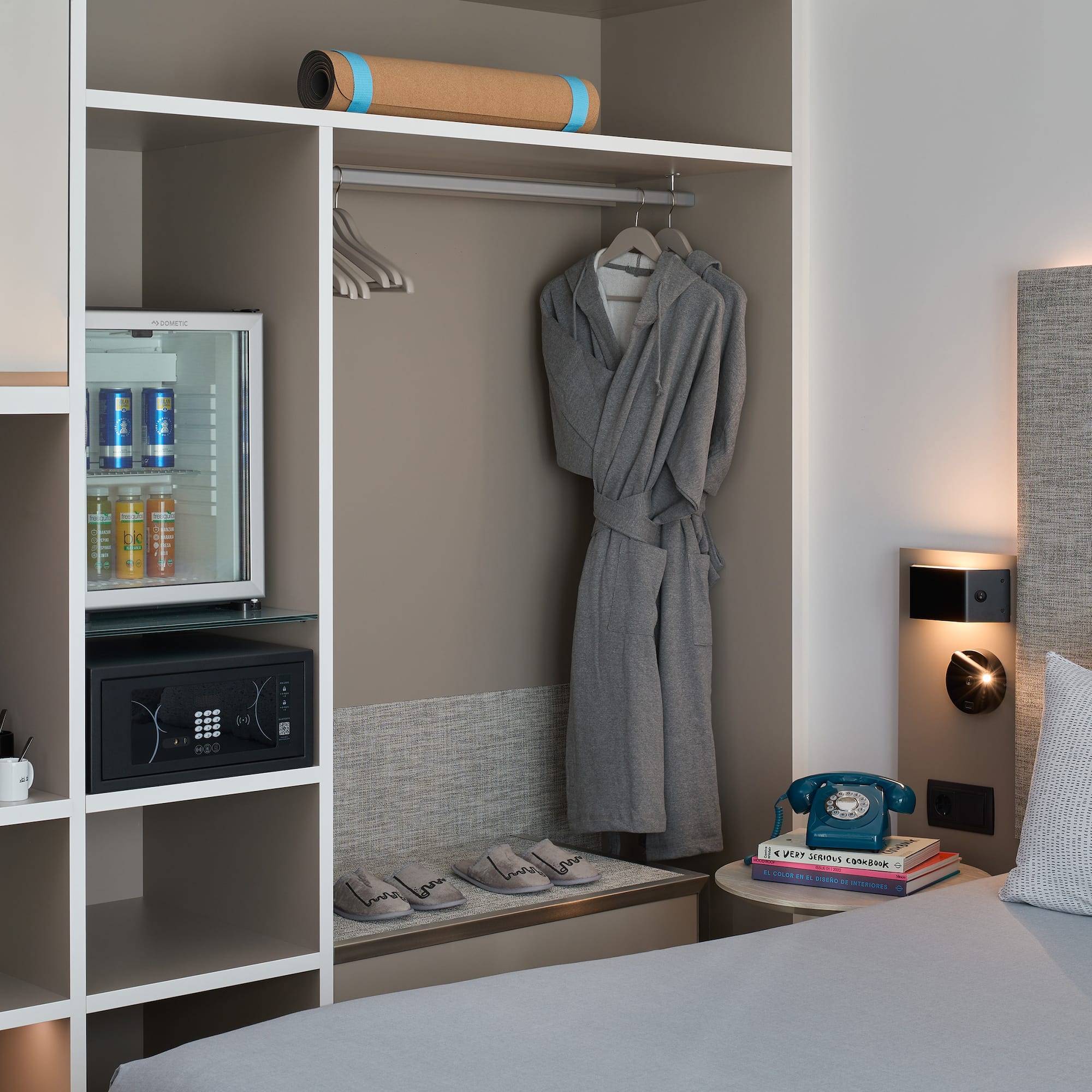 a room with a bed and a robe on a swinger