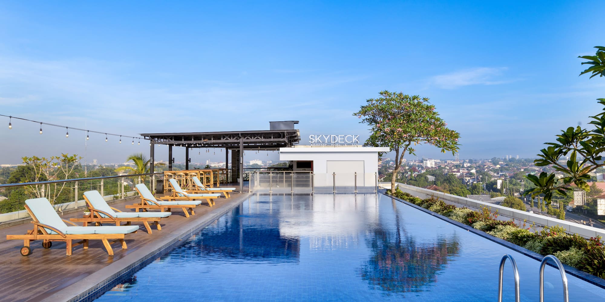 a pool with chairs and a roof top