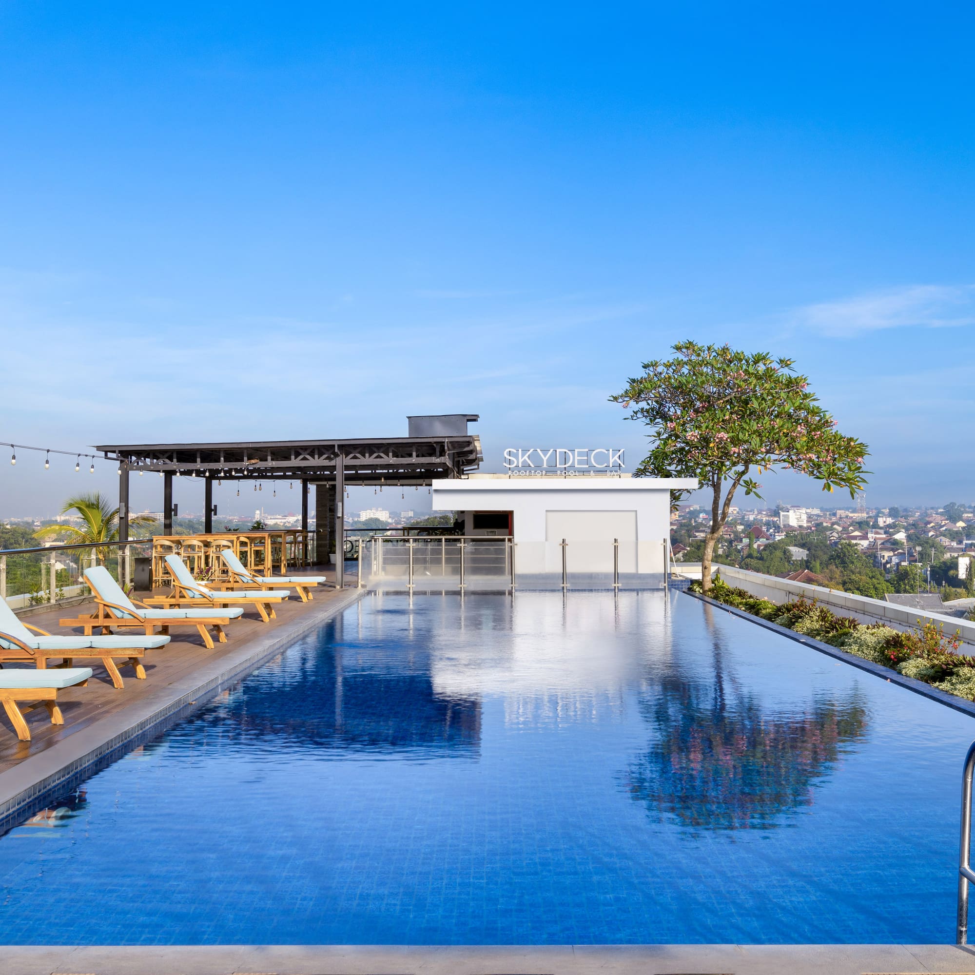 a pool with chairs and a roof top