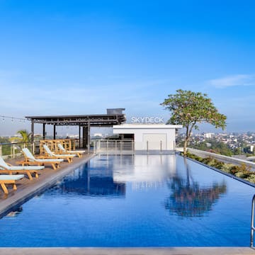 a pool with chairs and a roof top