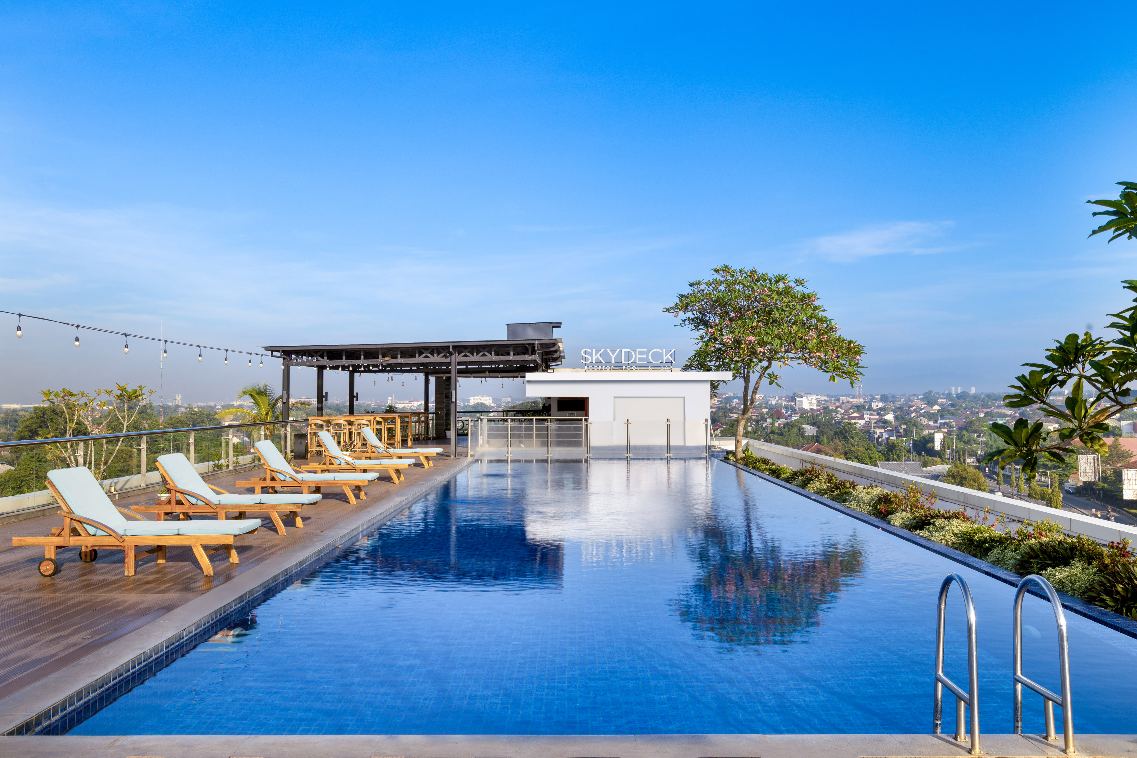 a pool with chairs and a roof top