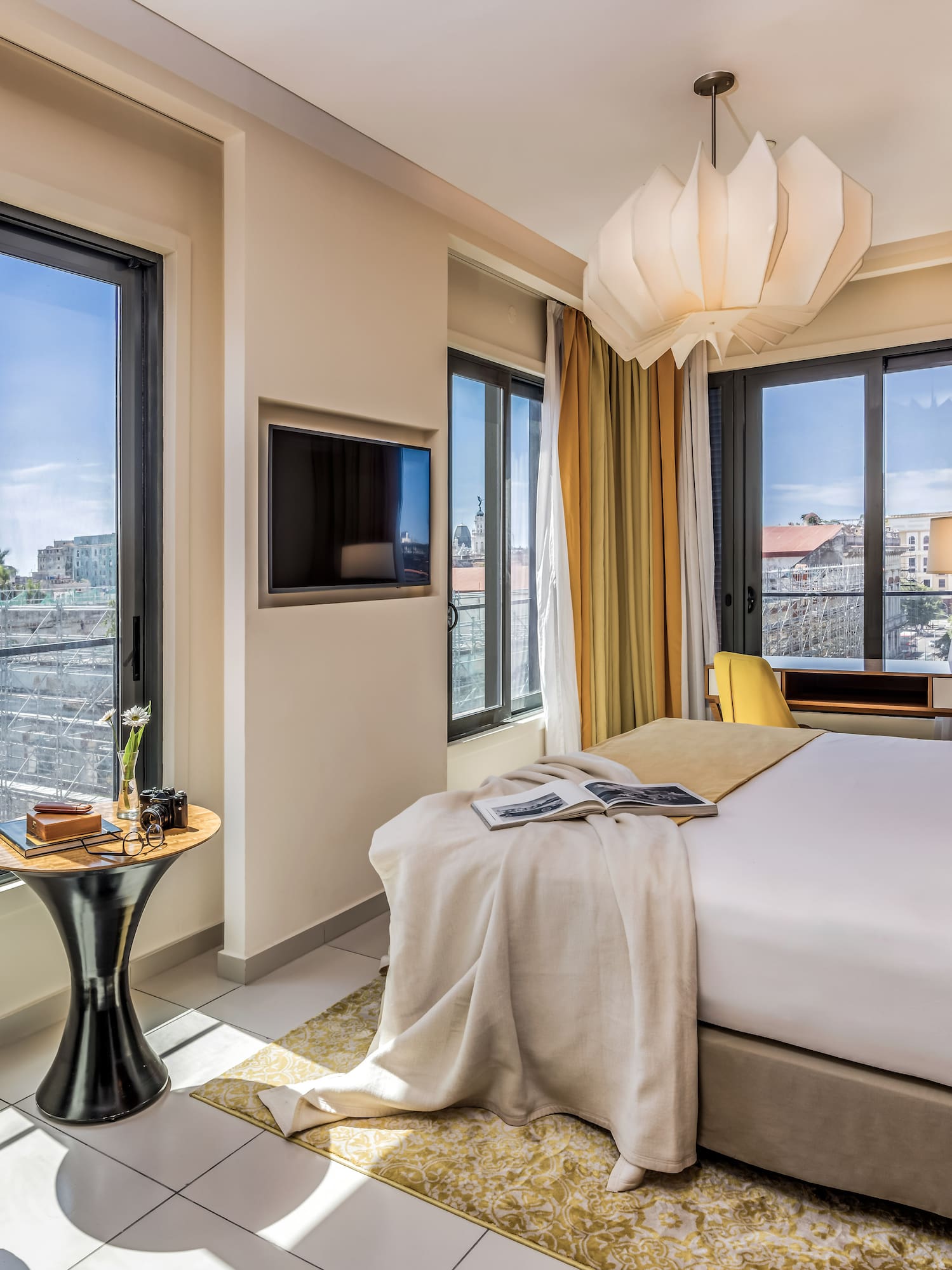 a bedroom with a bed and a tv