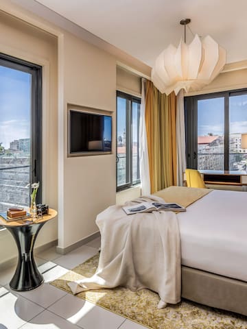 a bedroom with a bed and a tv