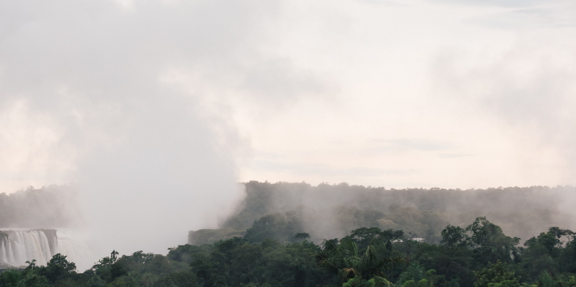 a woman in a pool with a waterfall in the background