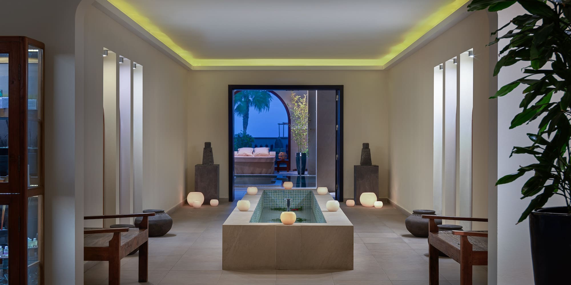 a room with a pool and benches