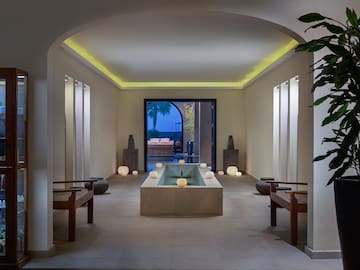 a room with a pool and benches