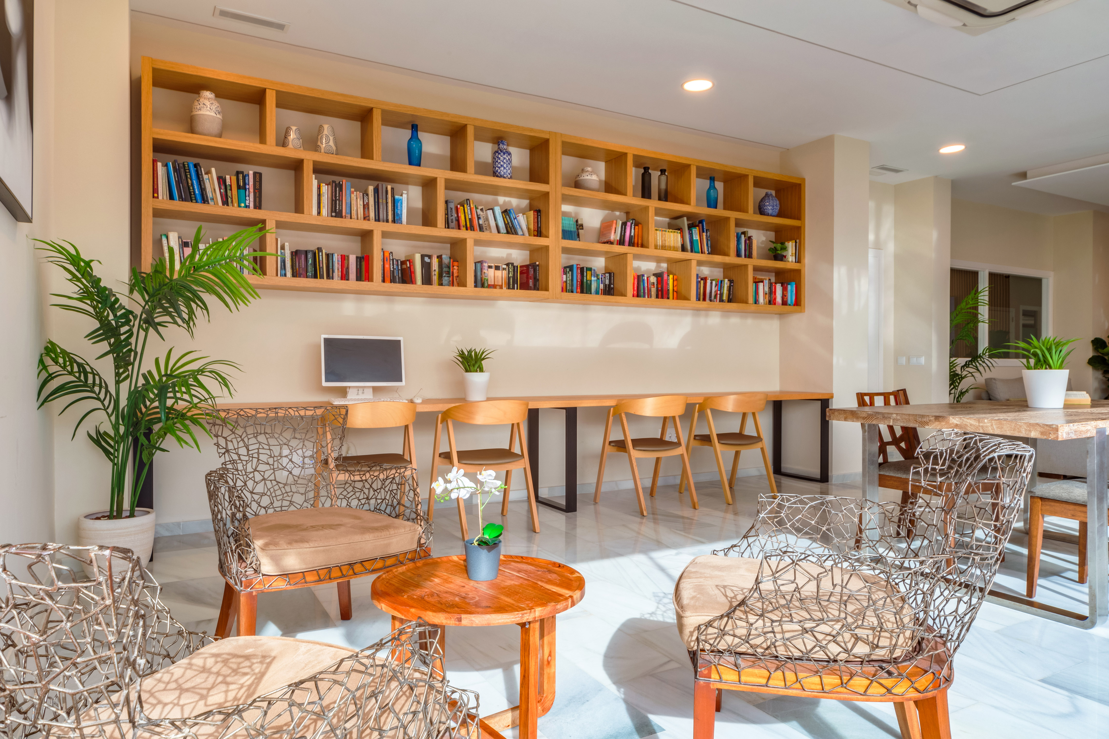 a room with a table and chairs and bookshelves