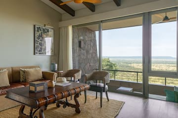 a living room with a table and chairs